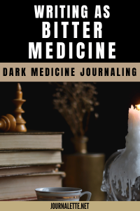 image of dark room with journals on table and candle with text box above reading writing as bitter medicine dark medicine journaling journalette